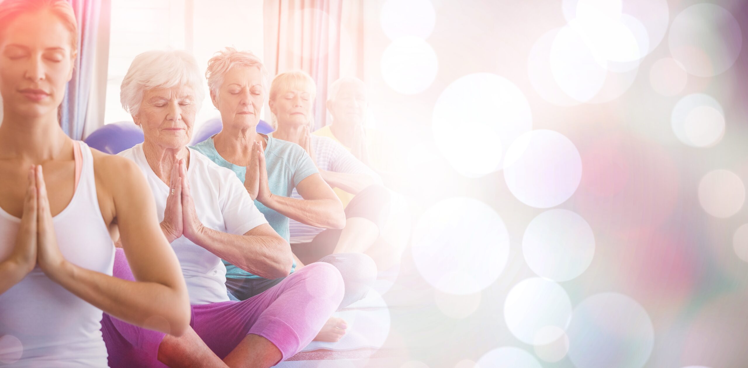 Front view of seniors relaxing with fitness instructor in retirement house